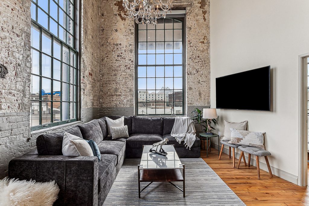 Cozy seating and open floor plan with sweeping views of downtown river front New Orleans